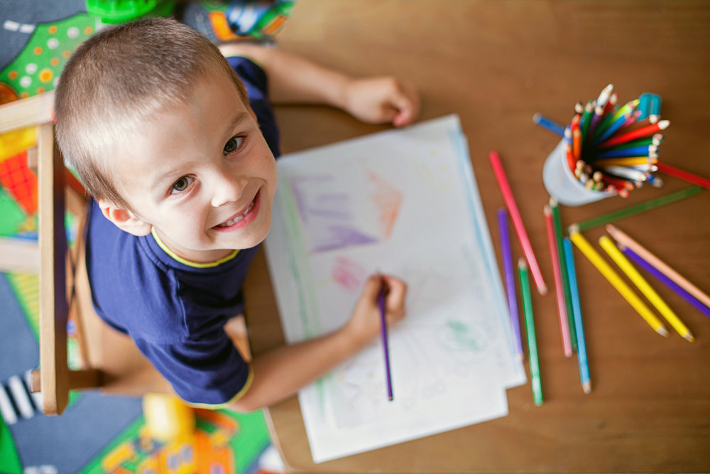 boy smiling drawing