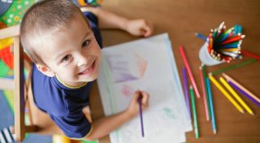 boy smiling drawing