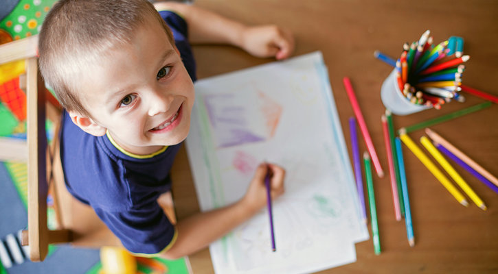 boy smiling drawing